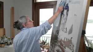 Monica Camin painting in her studio
