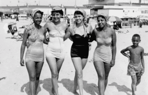 A black and white historical image of beachgoers in Atlantic City