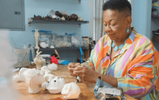 Dollmaker Kimberly Camp works in her studio.